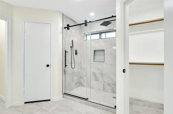 a bathroom with a glass shower door