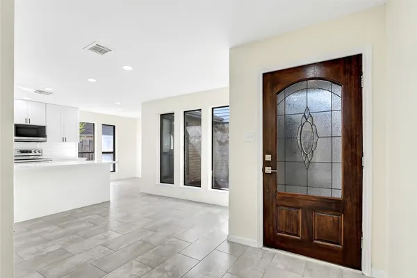 a living room with stainless steel appliances kitchen island granite countertop a refrigerator and a stove