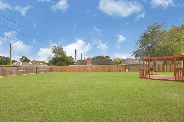 a view of a field of grass and trees