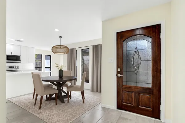 a dining room with furniture and window