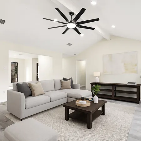 a living room with furniture and a ceiling fan