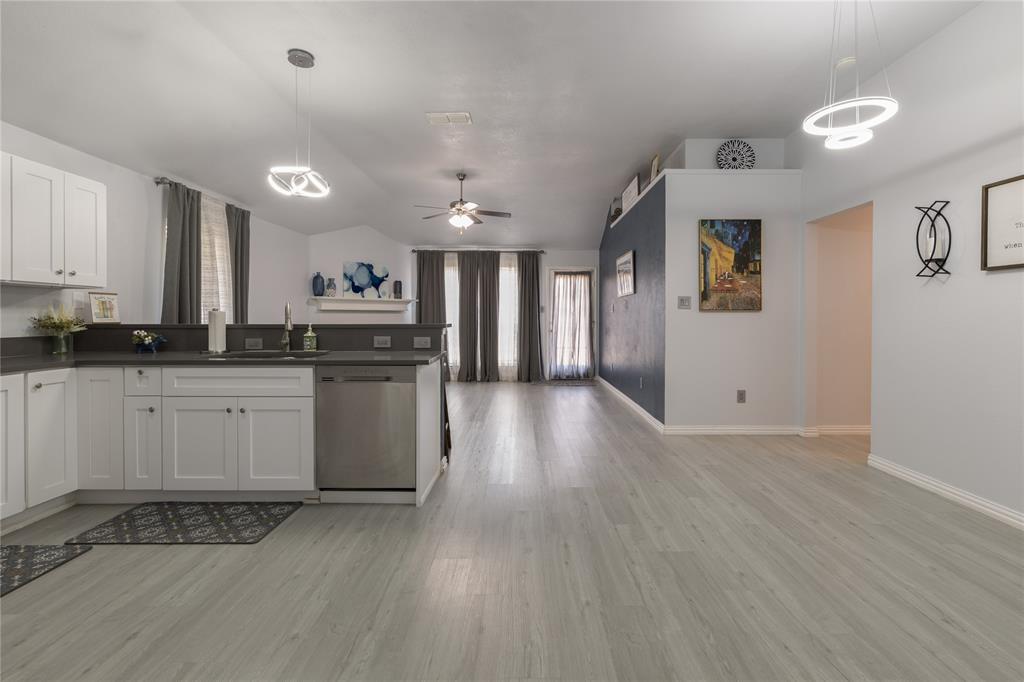 7313 Diamond Springs Trail Fort Worth, TX 76123 - Photo 11 of 40 a kitchen with stainless steel appliances granite countertop a stove a sink and a refrigerator