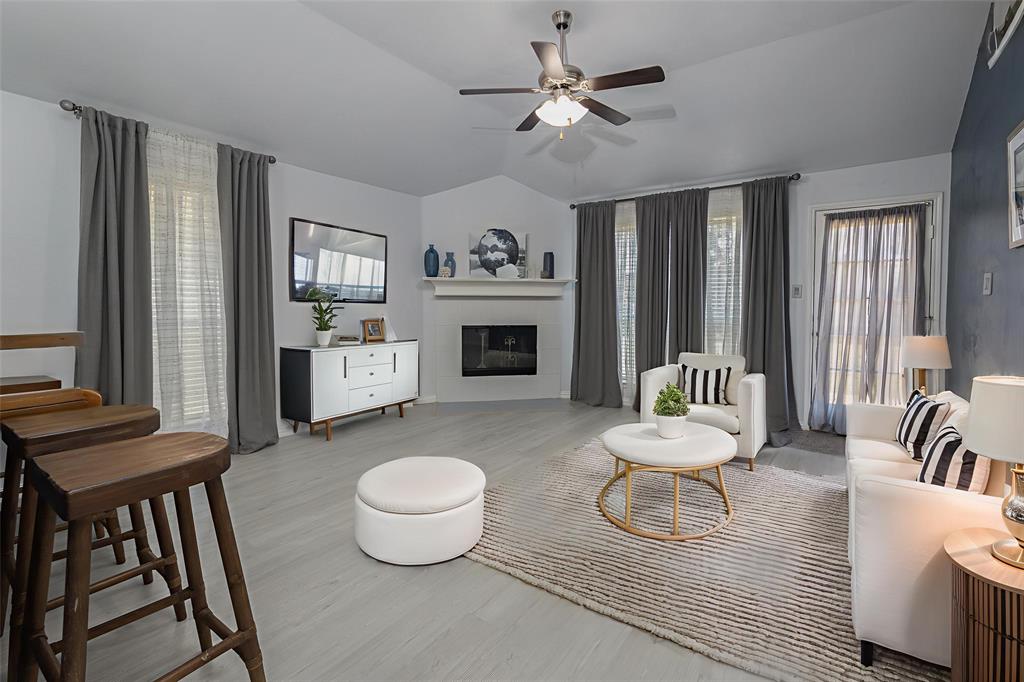 7313 Diamond Springs Trail Fort Worth, TX 76123 - Photo 14 of 40 a living room with furniture a fireplace and a flat screen tv