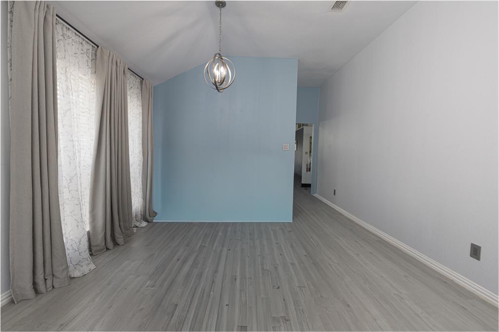 7313 Diamond Springs Trail Fort Worth, TX 76123 - Photo 19 of 40 an empty room with wooden floor and windows