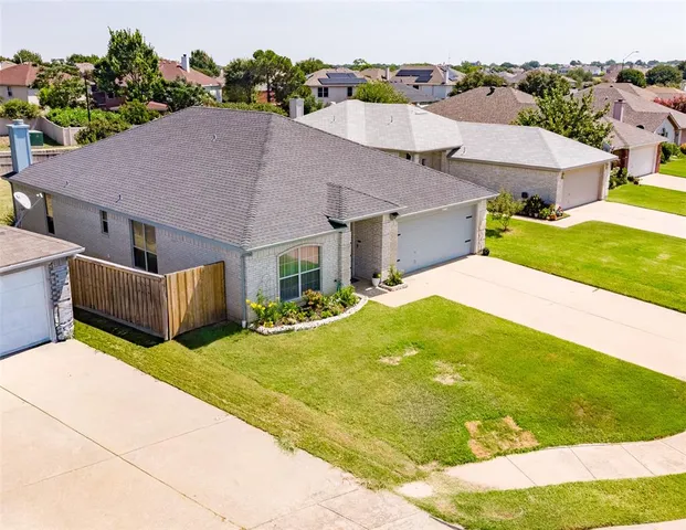 a aerial view of a house with swimming pool and a yard