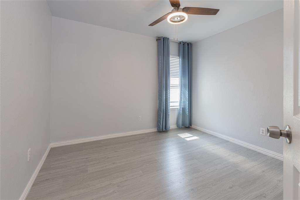 7313 Diamond Springs Trail Fort Worth, TX 76123 - Photo 25 of 40 an empty room with wooden floor and windows