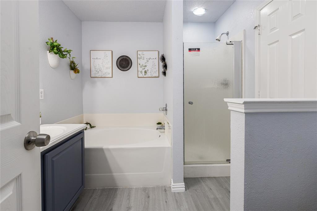 7313 Diamond Springs Trail Fort Worth, TX 76123 - Photo 31 of 40 a bathroom with a bathtub and a shower