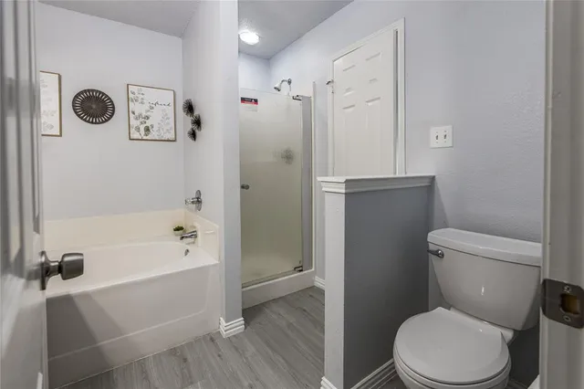 a bathroom with a sink a toilet and shower curtain