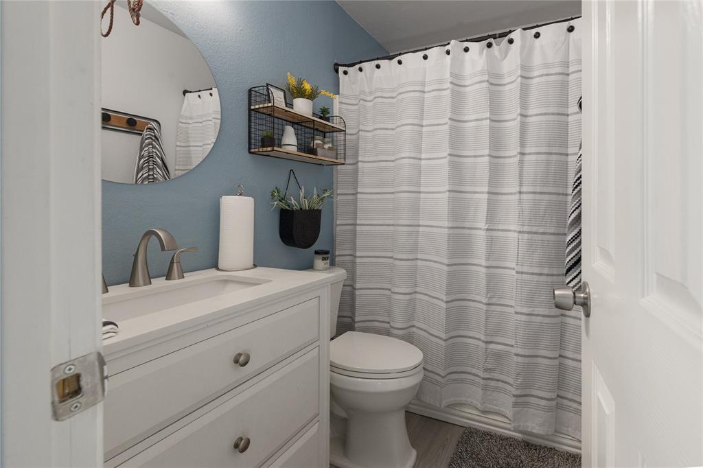 7313 Diamond Springs Trail Fort Worth, TX 76123 - Photo 33 of 40 a bathroom with a sink a toilet and shower curtain