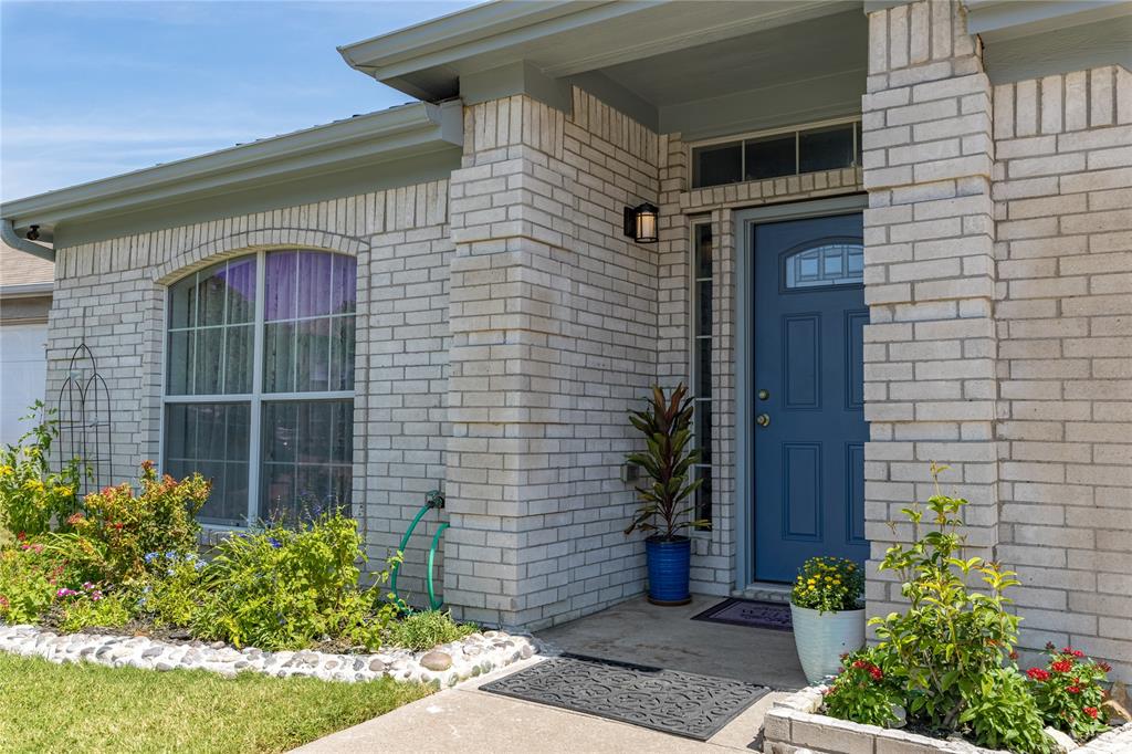 7313 Diamond Springs Trail Fort Worth, TX 76123 - Photo 5 of 40 a brick building with a potted plant and a window
