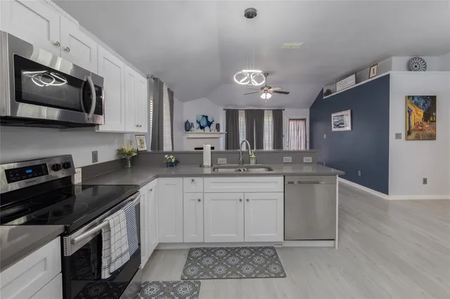 a kitchen with stainless steel appliances granite countertop a sink and a stove top oven