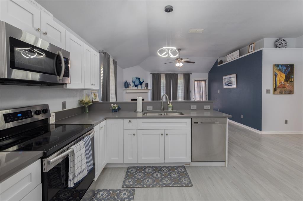 7313 Diamond Springs Trail Fort Worth, TX 76123 - Photo 8 of 40 a kitchen with stainless steel appliances granite countertop a sink and a stove top oven