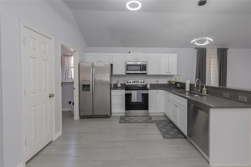 7313 Diamond Springs Trail Fort Worth, TX 76123 - Photo 10 of 40 a large kitchen with cabinets and stainless steel appliances