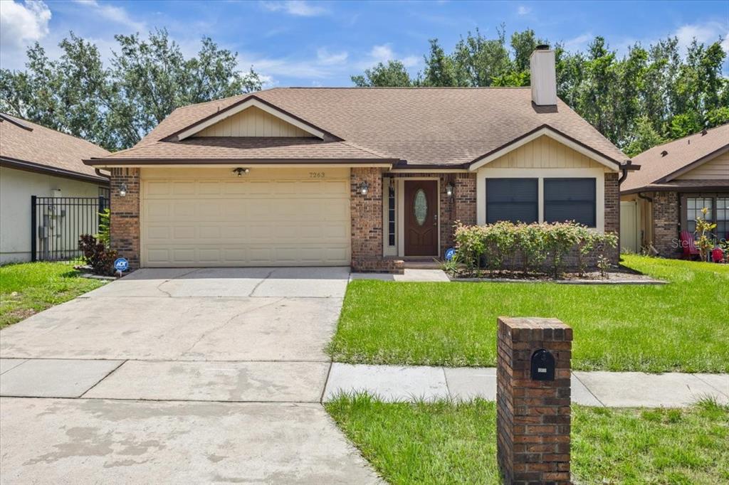 a front view of house with yard and green space