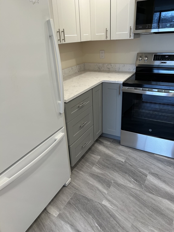 50 Main Street, Unit 409 Watertown, MA 02472 - Photo 5 of 9 a kitchen with a sink and cabinets