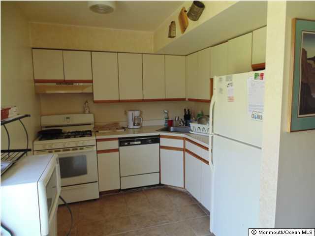 2006 Sawmill Road Brick, NJ 08724 - Photo 4 of 6 a white refrigerator freezer sitting inside of a kitchen