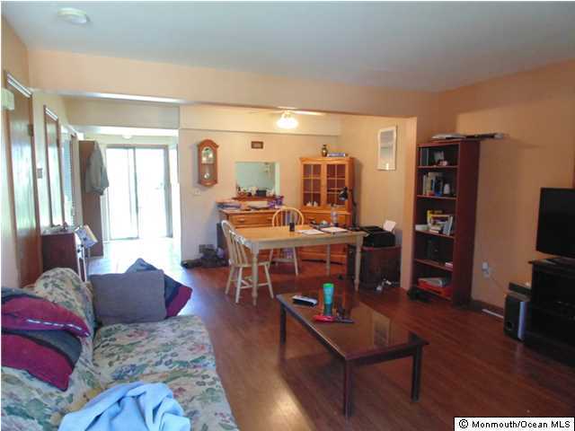 2006 Sawmill Road Brick, NJ 08724 - Photo 6 of 6 a living room with furniture a wooden floor and a flat screen tv