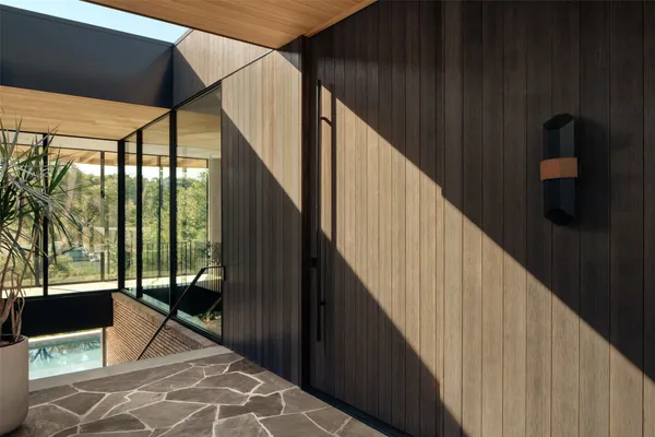 a bedroom with a bed and glass window