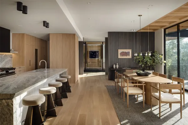 a large dining space with furniture window and wooden floor