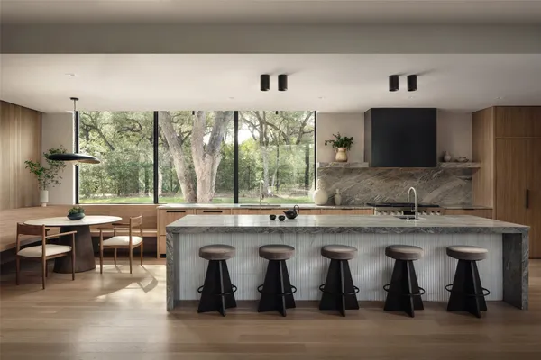 a kitchen with lots of counter space and windows