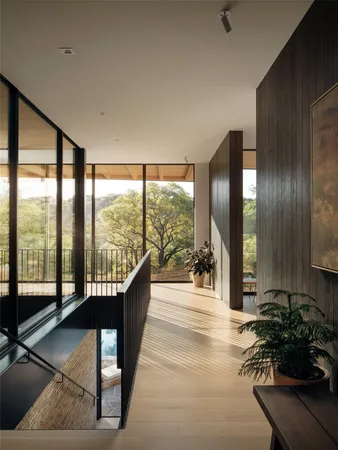 a living room with furniture and large windows