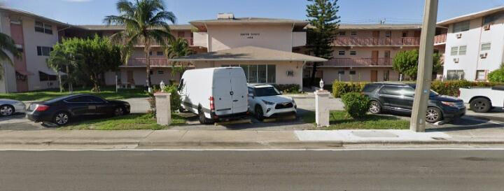 1480 East Sample Road, Unit 207 Pompano Beach, FL 33064 - Photo 13 of 14 a view of a car parked in front of a building