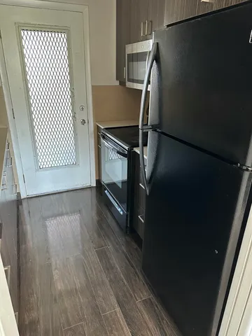 a view of a room with wooden floor