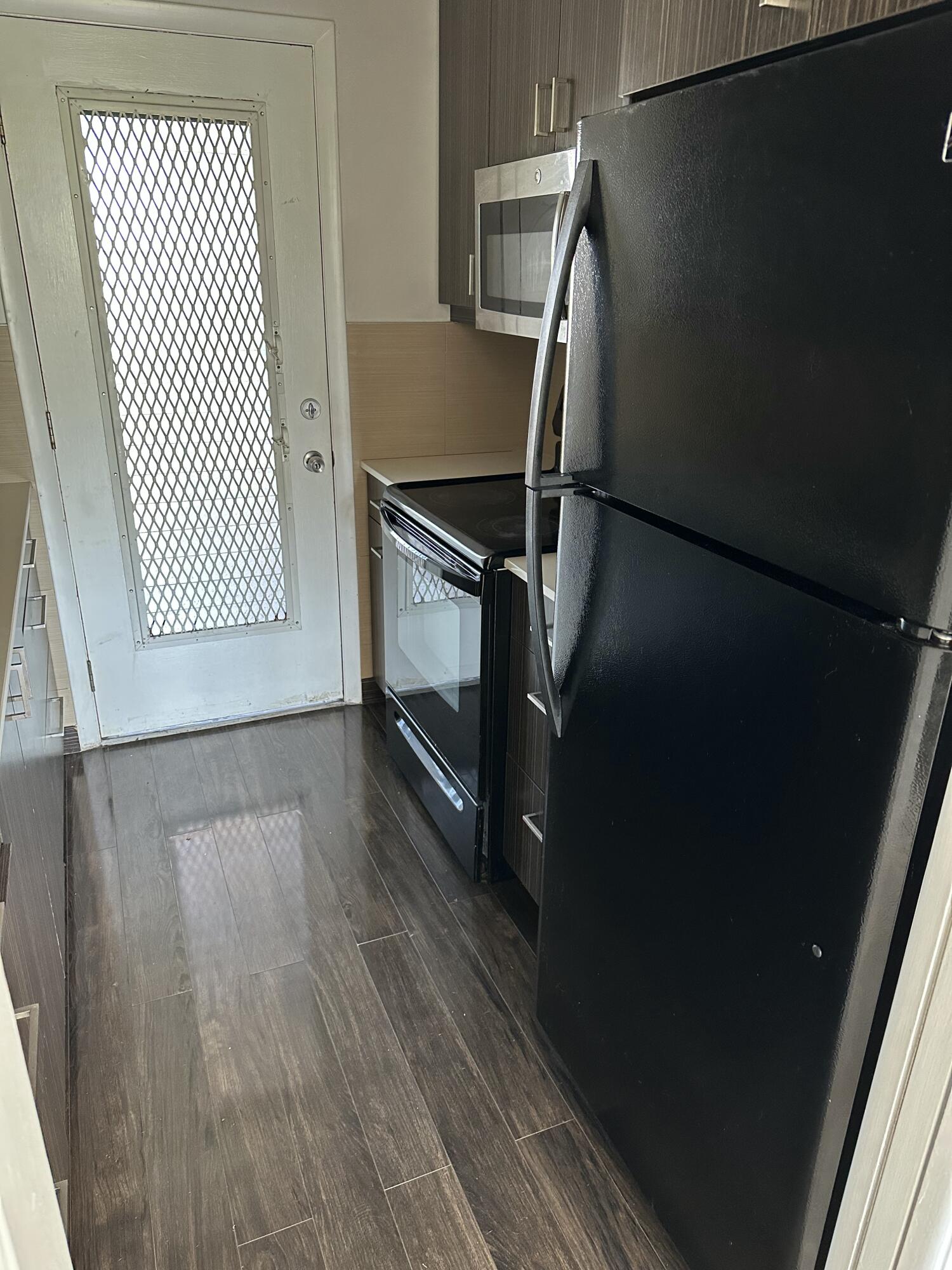 1480 East Sample Road, Unit 207 Pompano Beach, FL 33064 - Photo 2 of 14 a view of a room with wooden floor