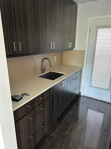 a kitchen with a sink and cabinets