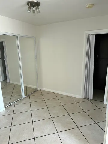 a view of an empty room and a window