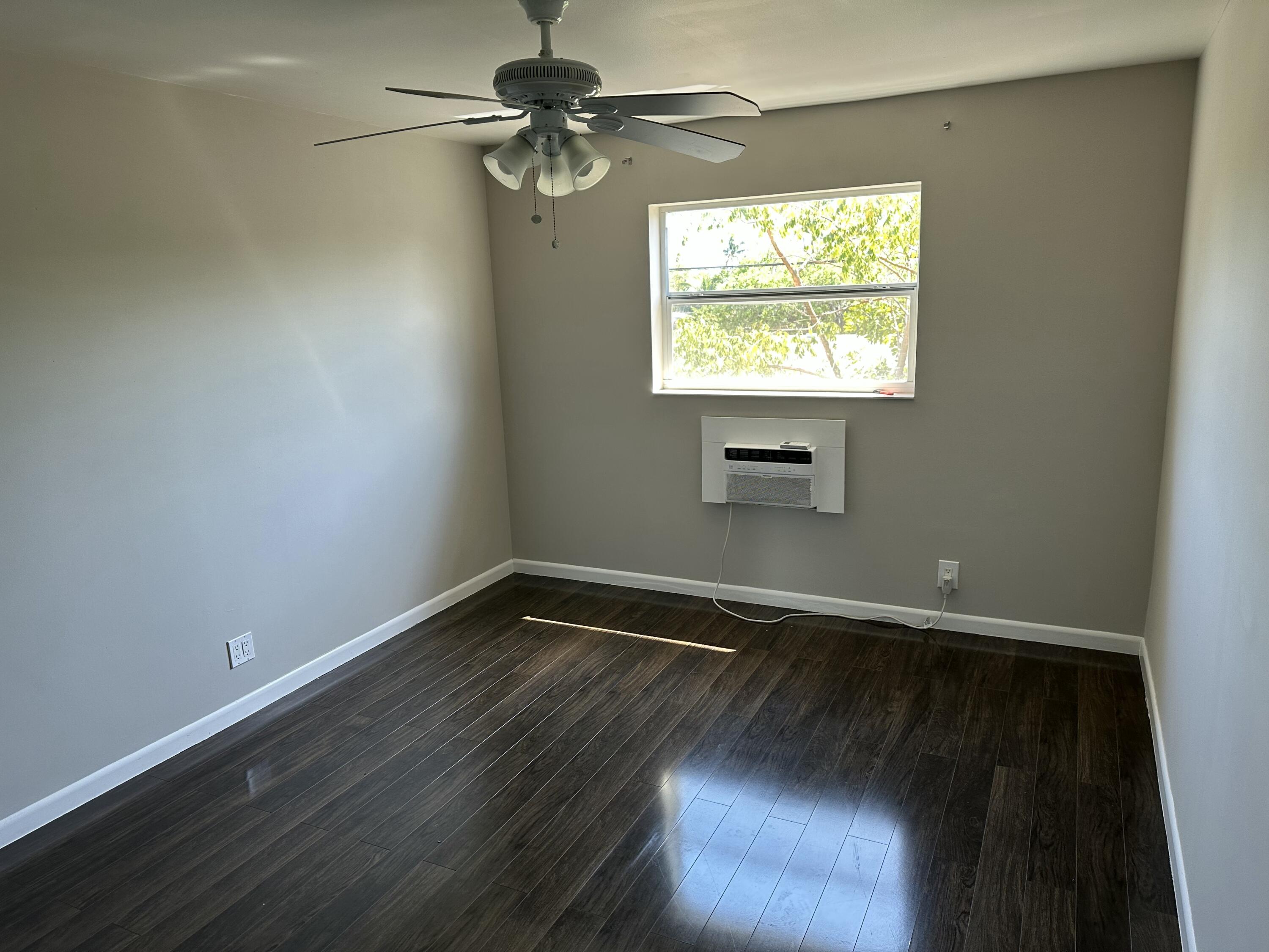 1480 East Sample Road, Unit 207 Pompano Beach, FL 33064 - Photo 7 of 14 a view of an empty room with a window