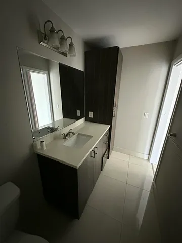 a kitchen with a sink and a mirror