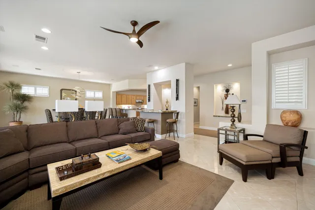 a living room with furniture and a pool table