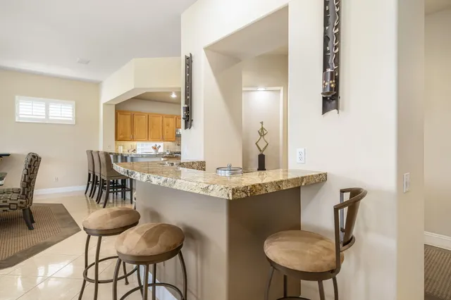 a dining room with table chairs and wooden floor