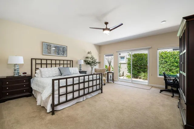 a bed sitting in a spacious bedroom next to a window