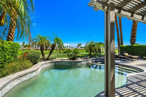 a view of a swimming pool with a patio
