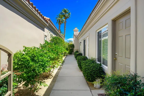 a view of a pathway both side of the house