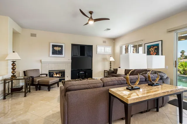 a living room with furniture a fireplace and a window