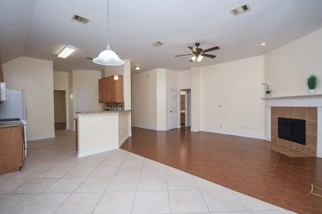 a view of a kitchen with an empty space and a fireplace