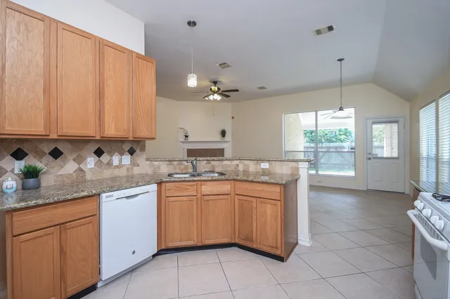 a kitchen with a sink cabinets and window