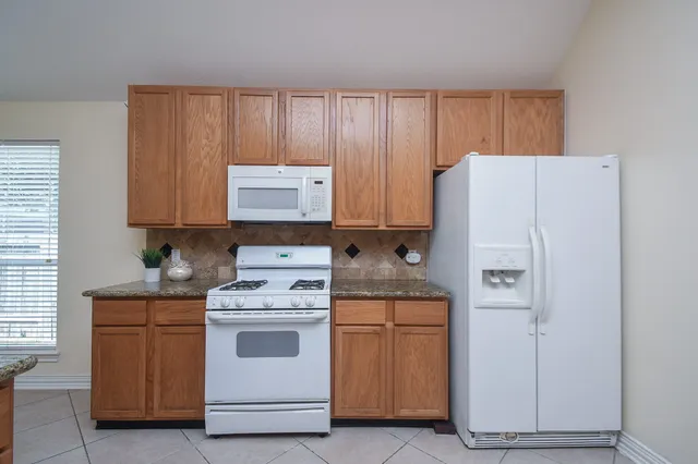 a kitchen with a stove and a refrigerator