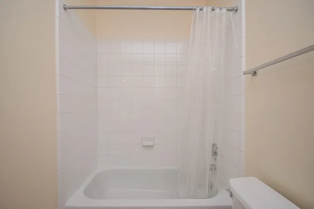 a bathroom with a shower and a toilet