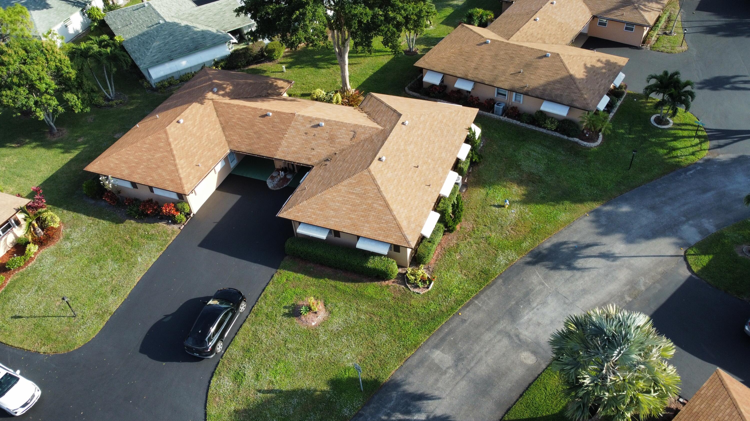 an aerial view of a house with garden space and street view