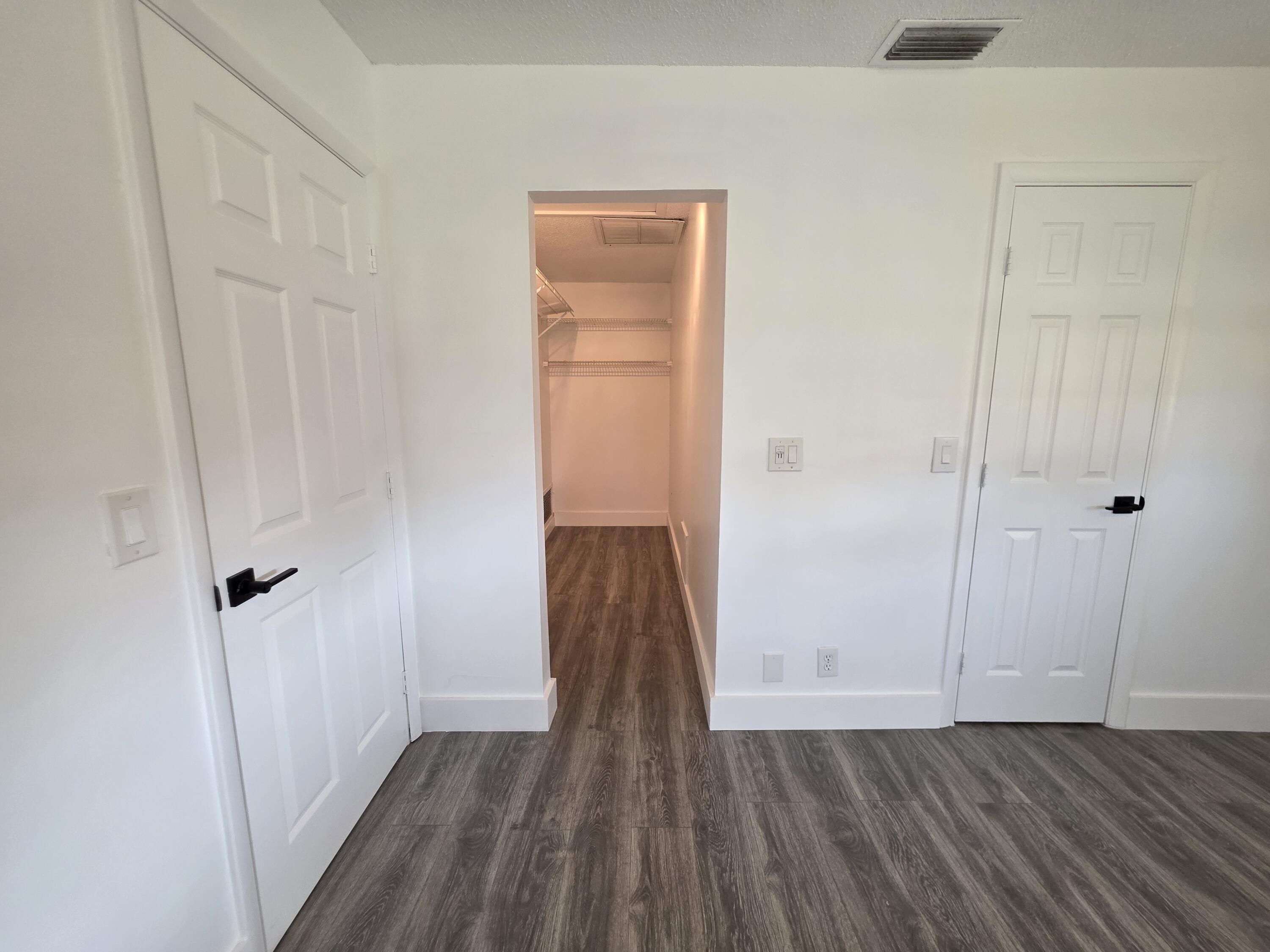 718 Whippoorwill Lane Delray Beach, FL 33445 - Photo 16 of 38 a view of an empty room with wooden floor