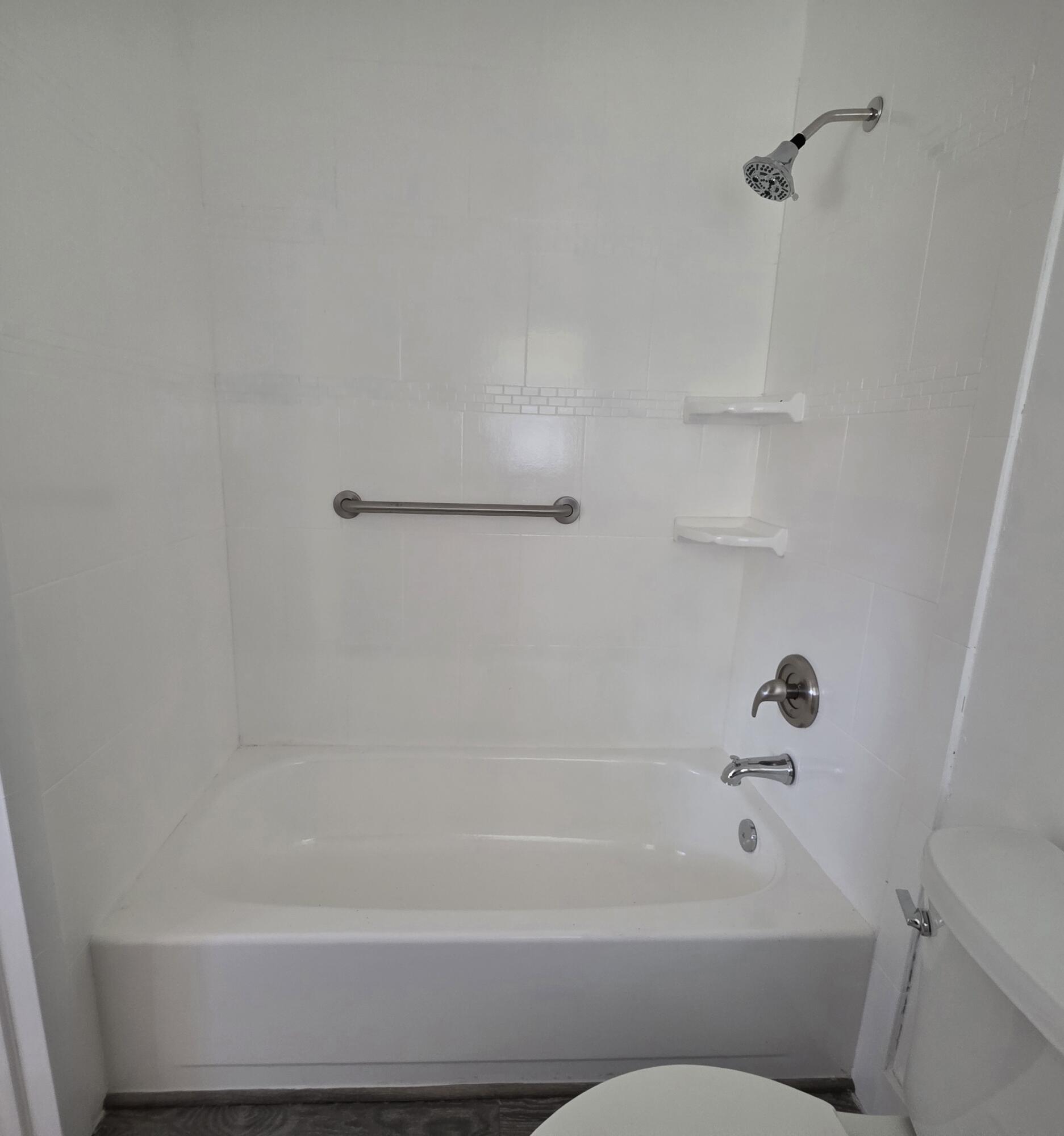 718 Whippoorwill Lane Delray Beach, FL 33445 - Photo 20 of 38 a bathroom with a bathtub and a shower