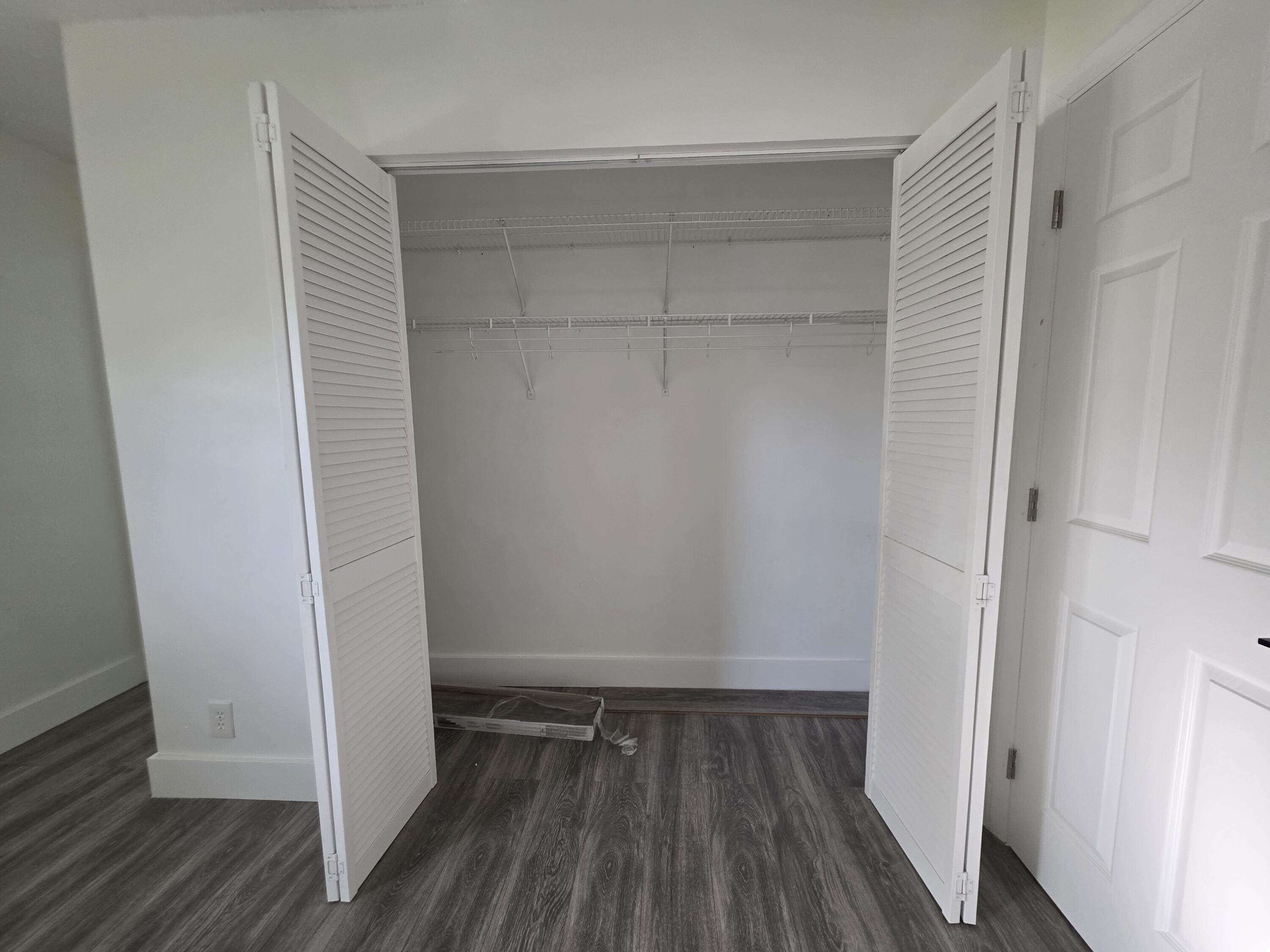 718 Whippoorwill Lane Delray Beach, FL 33445 - Photo 22 of 38 a view of walk in closet with wooden floor