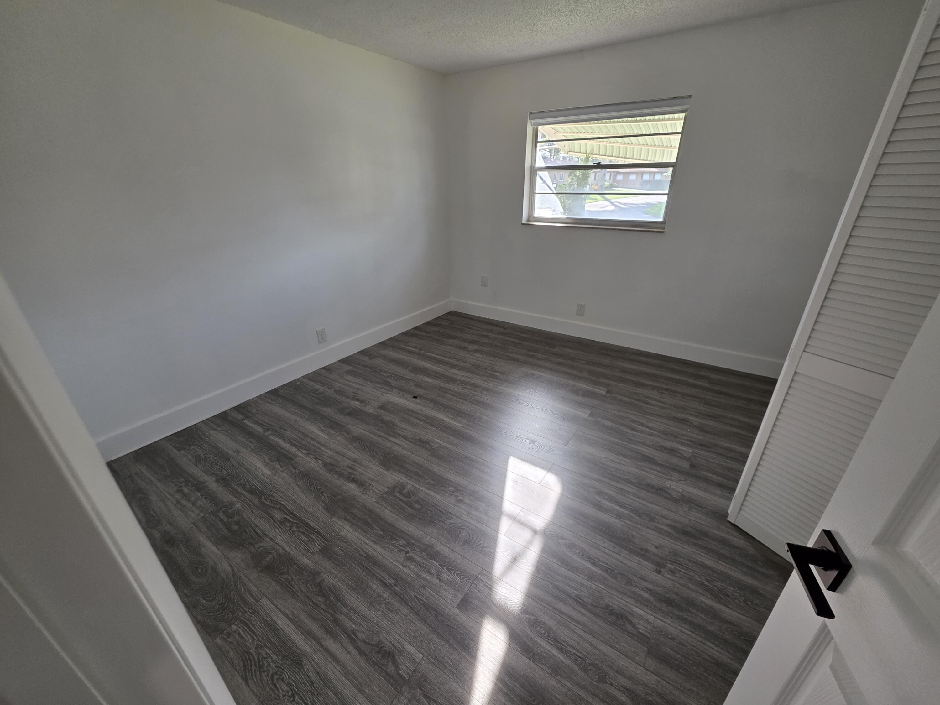 718 Whippoorwill Lane Delray Beach, FL 33445 - Photo 23 of 38 a view of an empty room and window