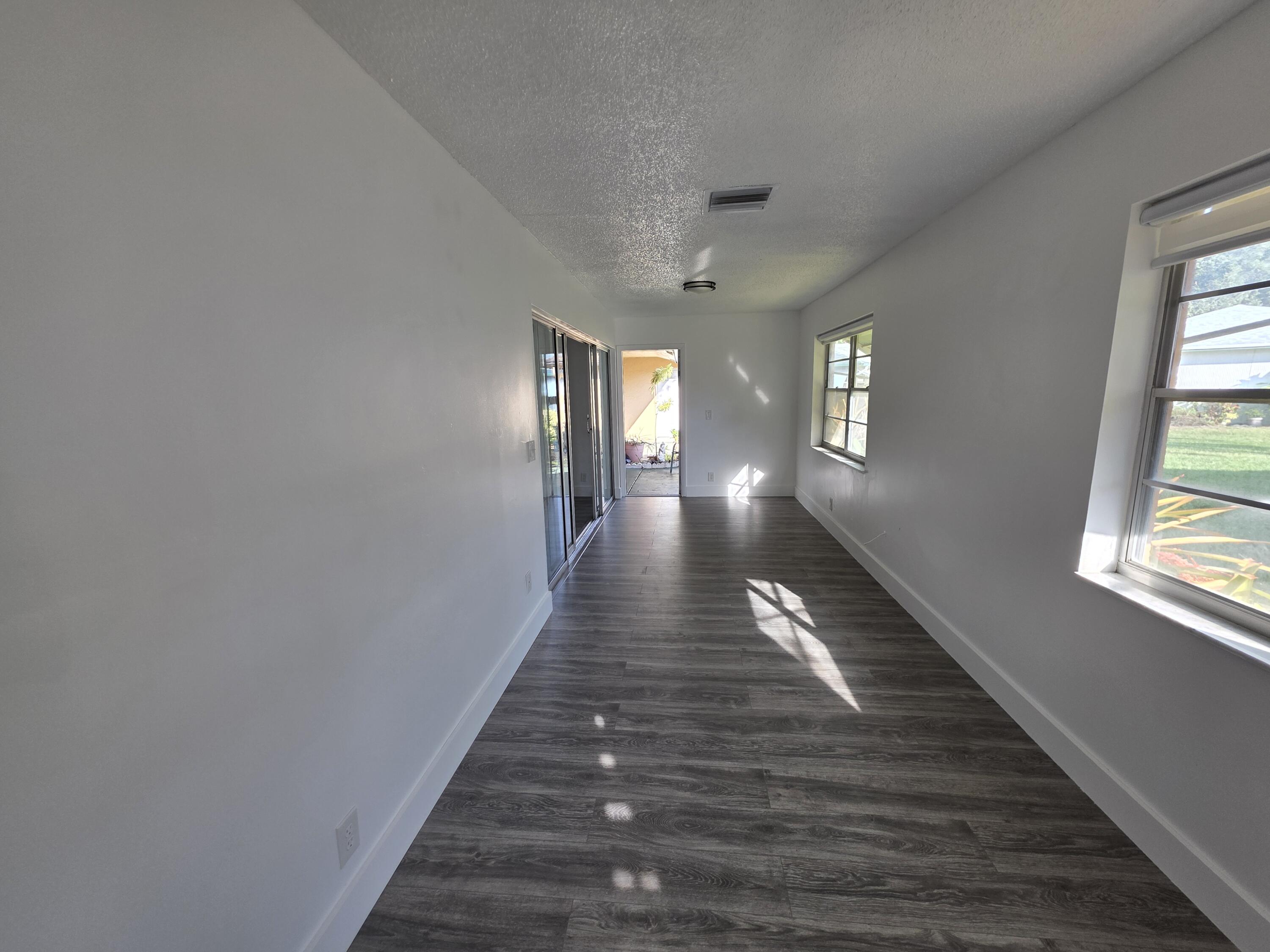 718 Whippoorwill Lane Delray Beach, FL 33445 - Photo 27 of 38 a view of gallery with wooden floor