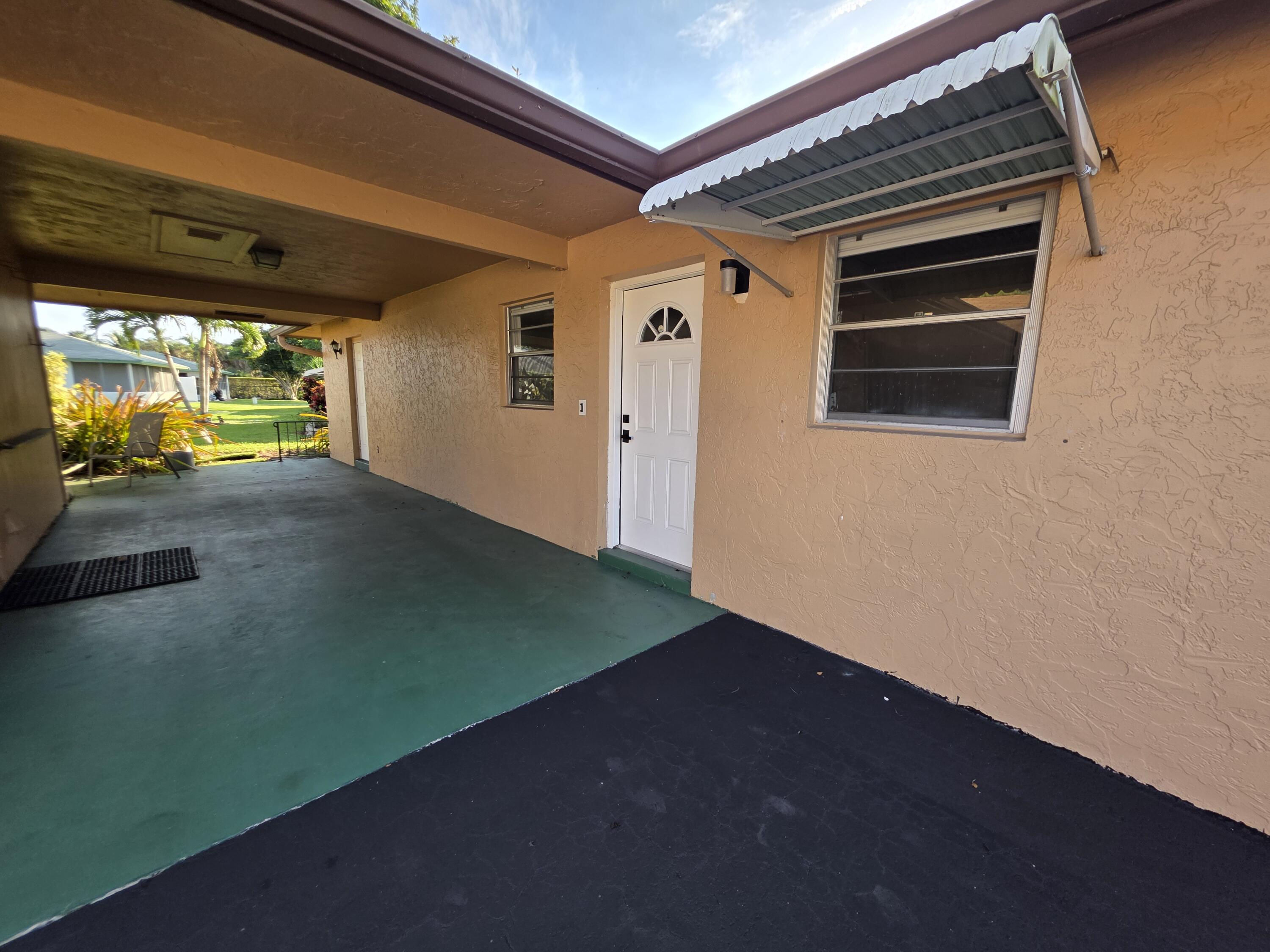 718 Whippoorwill Lane Delray Beach, FL 33445 - Photo 29 of 38 a view of a porch