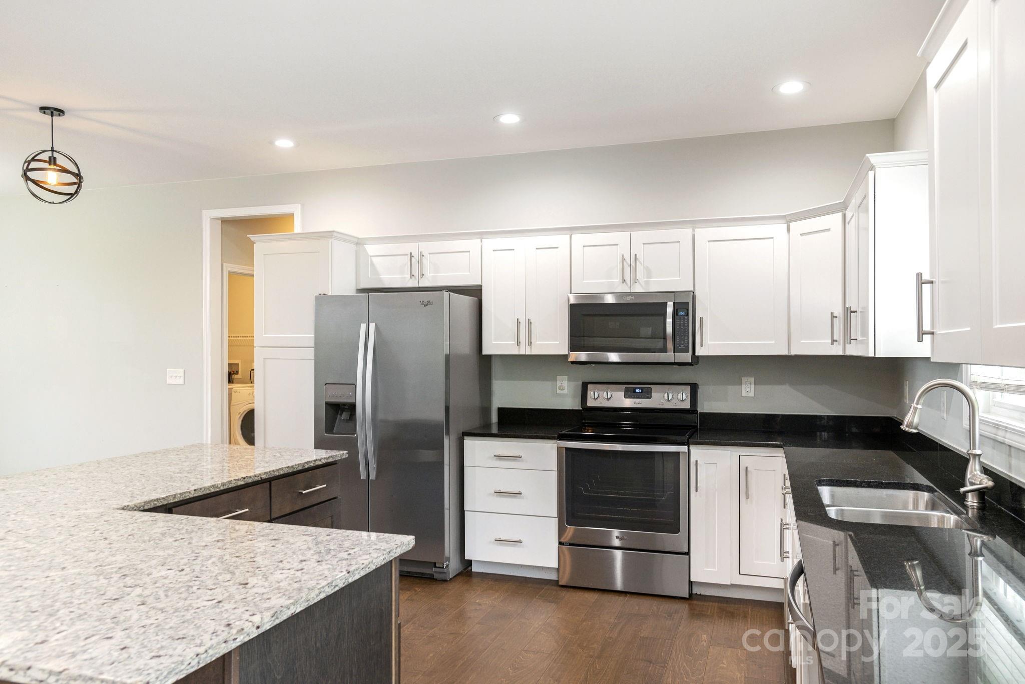 76 Tryon View Drive Flat Rock, NC 28731 - Photo 11 of 30 a kitchen with stainless steel appliances granite countertop a refrigerator and a stove